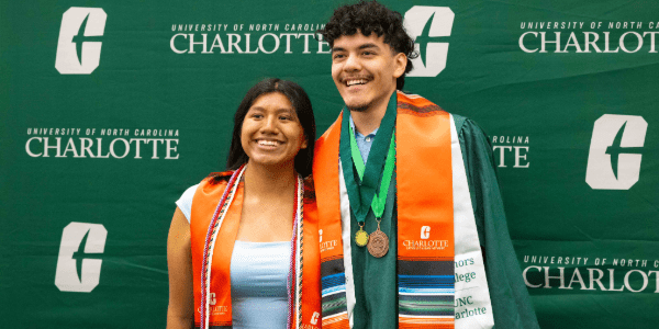 Two students smile at last semester's Forever a Niner celebration