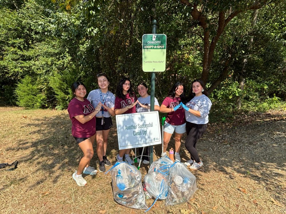 Lambda Theta Alpha sorority poses after cleaning up it's designated spot on campus (Fall 2025).