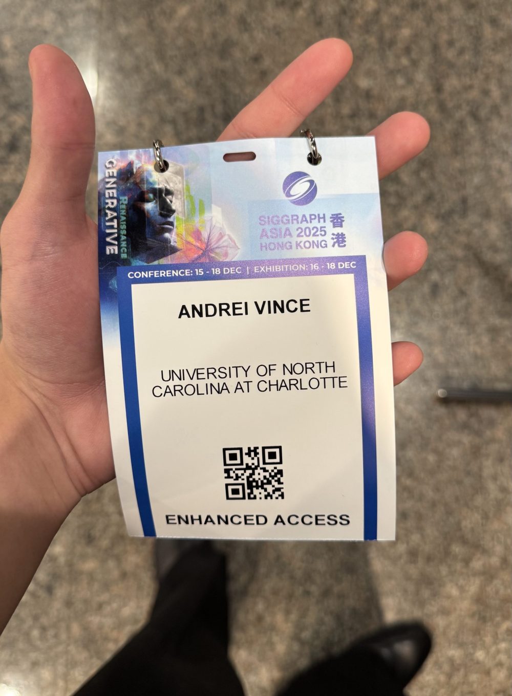 Andrei Vince holds credential at SIGGRAPH Asia