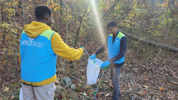 Two students pick up trash for the Adopt-a-Spot program
