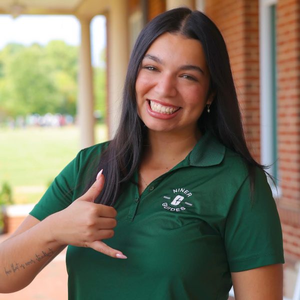 Maryjane Raya throws picks up in Niner Guides uniform