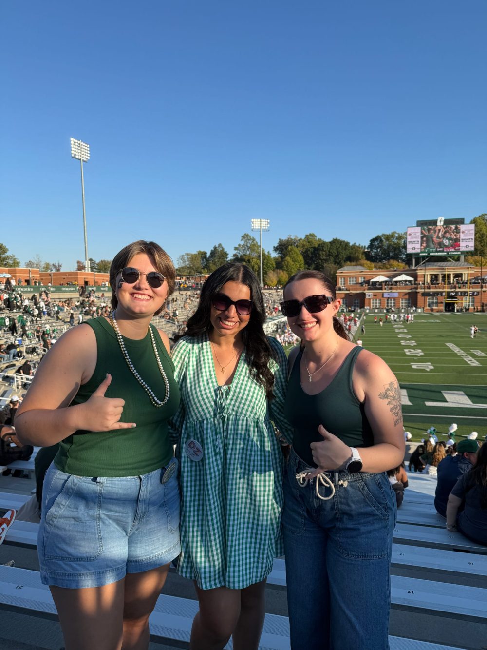 Maryjane Raya with friends at a football game at Jerry Richardson Stadium