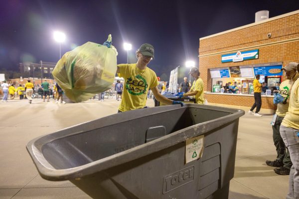 Logan David gathering waste at UNC Charlotte home football game