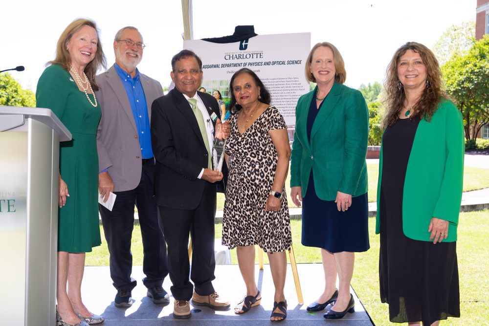 Ishwar and Shail Aggarwal (center) with Chancellor Sharon Gaber (l to r), Department Chair Glenn Boreman, Provost Jennifer Troyer and Dean Bernadette Donovan-Merkert during the dedication of the Aggarwal Department of Physics and Optical Science in the Klein College of Science.