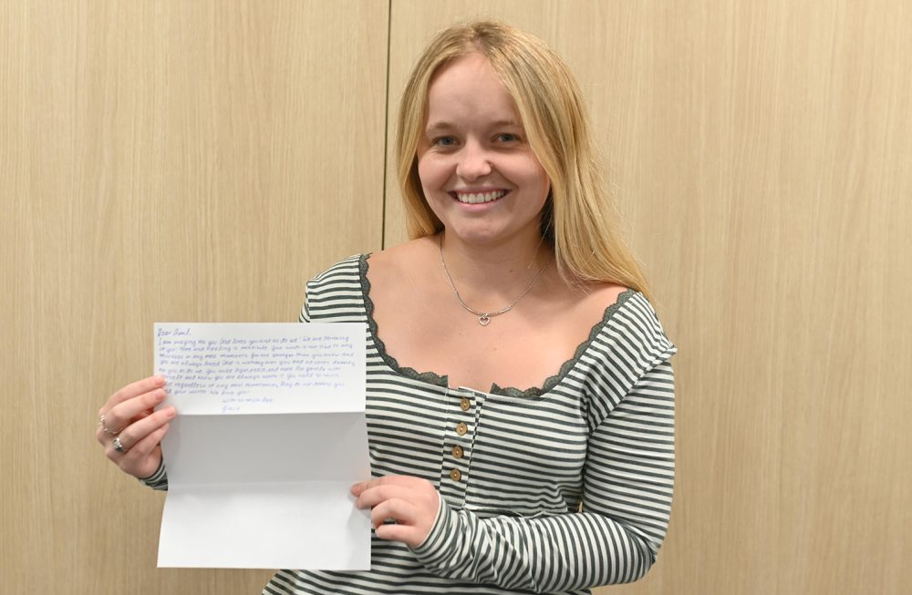 Gracie Bricker holds letter written to incarcerated individual