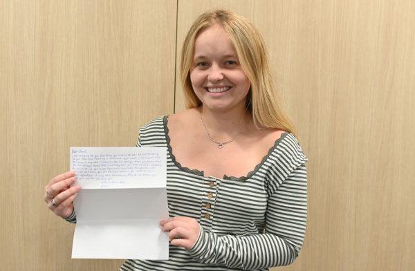 Gracie Bricker holds letter written to incarcerated individual
