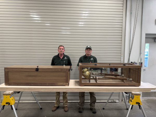 Watt and Coleman standing behind the two mace cases