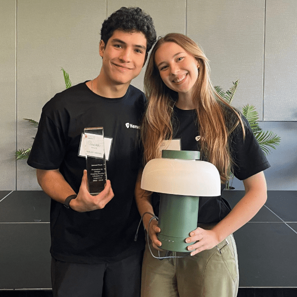 Andrei Vince and Verônica Vanti hold prize and Neevel prototype at Stanford Center on Longevity Design Challenge
