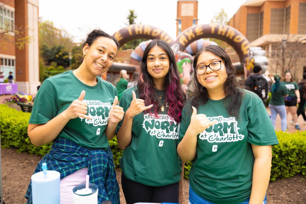 Health and Wellbeing representatives wearing "Wellbeing is the NORM at Charlotte" t-shirts
