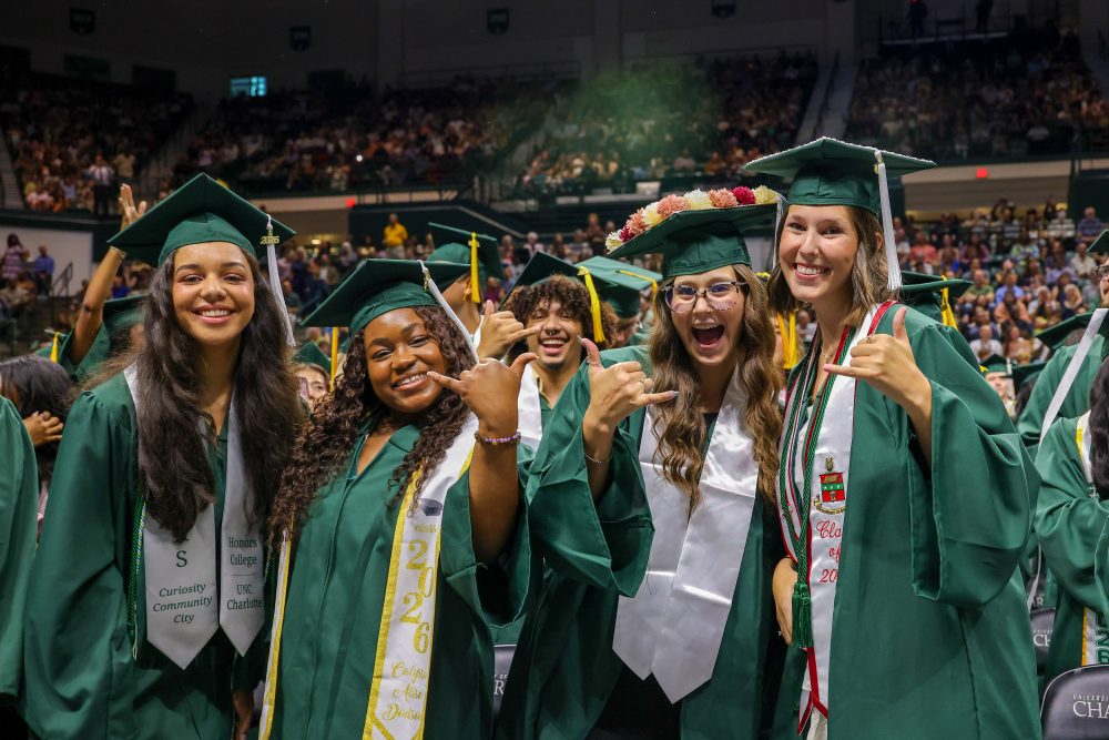 Smiling bachelor's degree graduates.