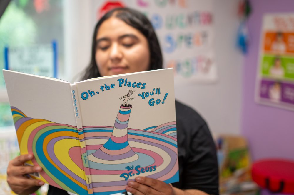 Joselyn Moreno reads "Oh, the Places You'll Go!" inside ourBRIDGE for KIDS classroom