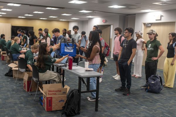 Laptops being distributed to UNC Charlotte first-generation students courtesy of E2D
