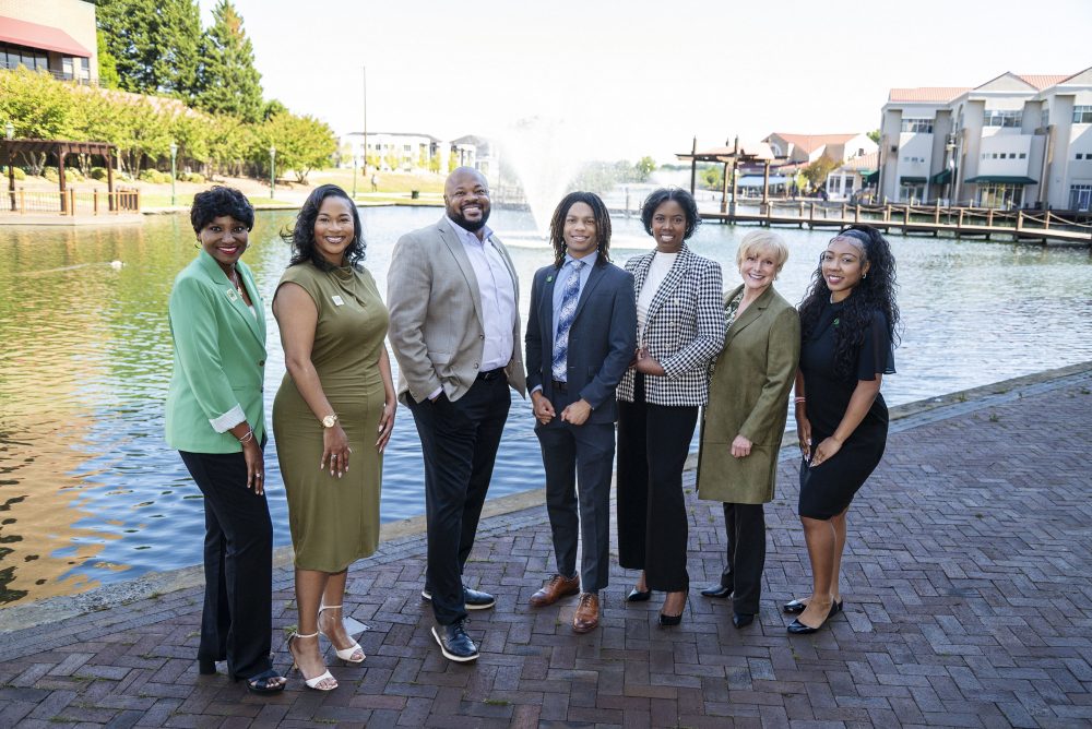 Myles Davis stands with University City Partners leaders (from left to right) Loán Lake, Tiffany Jordan, Keith Stanley, Shakira Hodges, Janelle Goodrich and Mya Allen