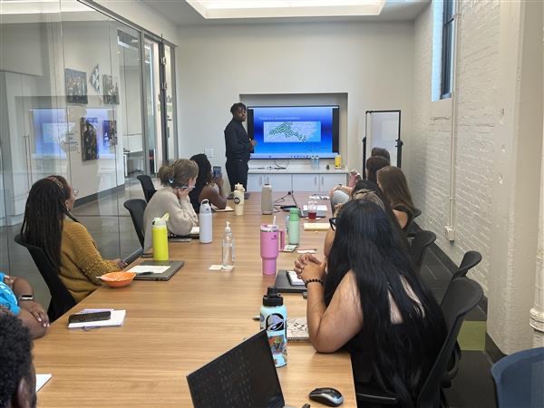 Rafael Reed presents at a Junior Achievement of Central Carolinas meeting room