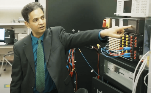 Sukumar Kamalasadan points at screen inside his lab