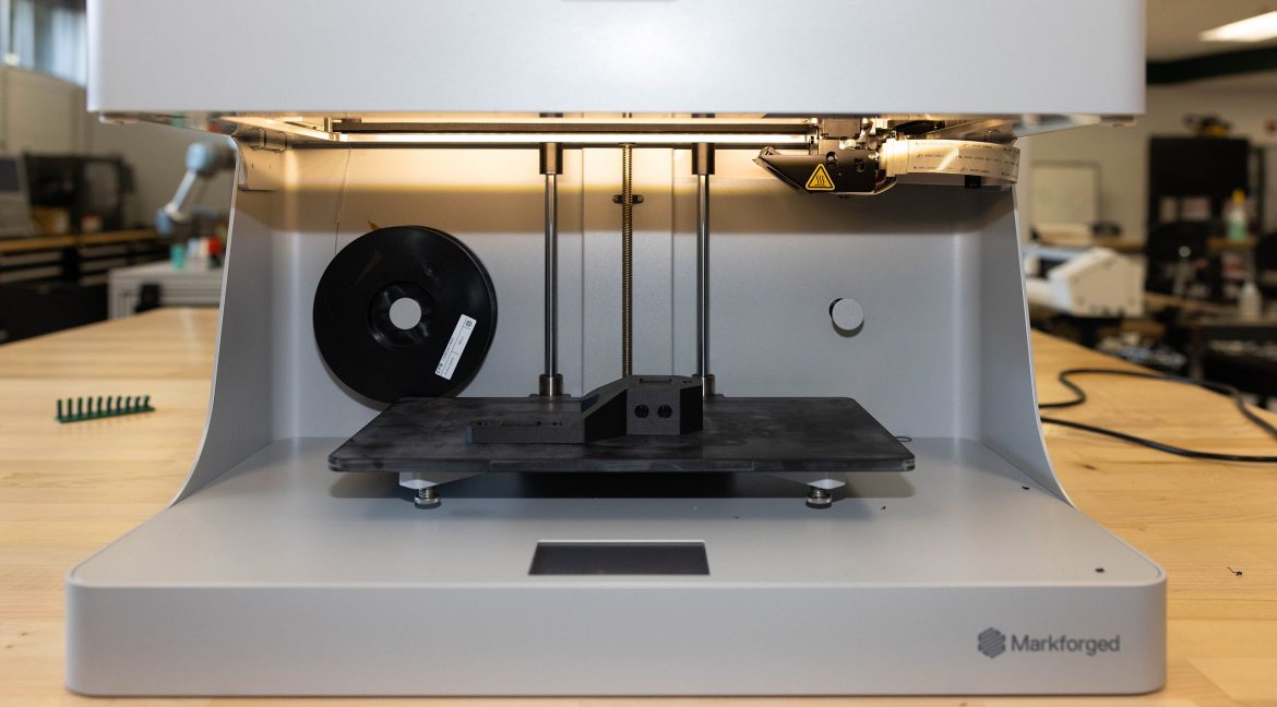 Carbon fiber component being produced on a 3D printer in a fabrication lab.