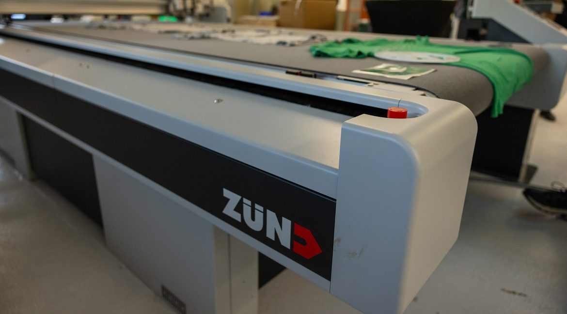 Zünd digital cutter processing sheet material on a flatbed cutting table.