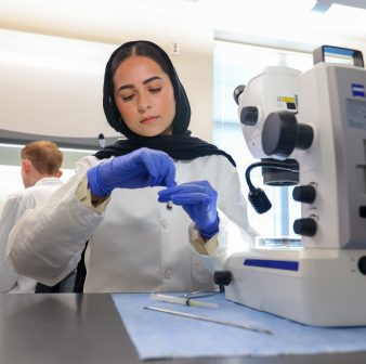 SS_Tick_Hunters_26009_7893_kpl Ieman Khan handles a tick test tube inside CIPHER lab