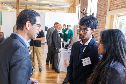 Siddarth Gaddam and Meghan Asaati talking with customers {{brizy_dc_image_alt imageSrc=