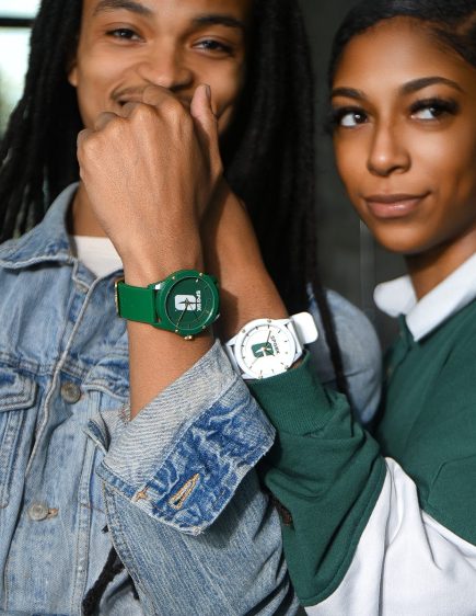 SPGBK-Watch-3 Two people posing together while showing wristwatches — one green and one white — featuring the UNC Charlotte “All-in-C” logo.